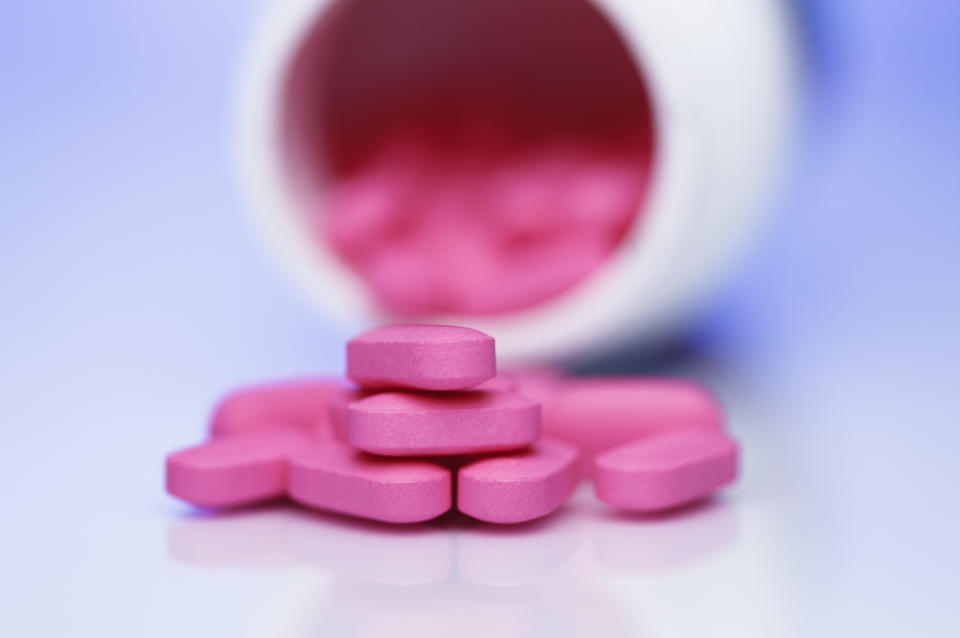 Pink pills coming out of bottle. Benadryl is an antihistamine most commonly used to relieve symptoms of allergy.