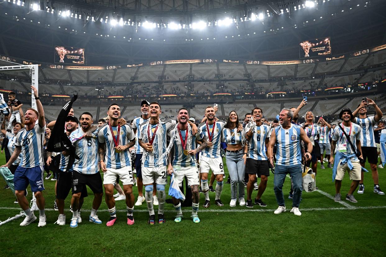 Argentina's players celebrate following the trophy ceremony after Argentina won the Qatar 2022 World Cup final football match between Argentina and France at Lusail Stadium in Lusail, north of Doha on December 18, 2022. (Photo by Anne-Christine POUJOULAT / AFP)