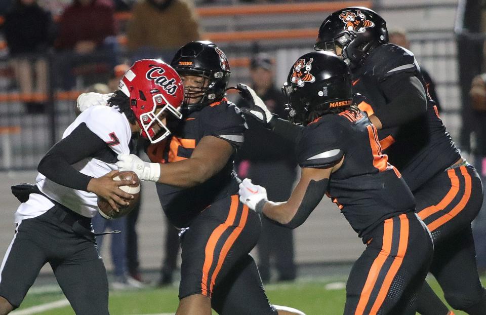 Westerville South Dominic Birtha, left, is sacked by Massillon's Michael Wright Jr,, second from left, as Shon Robinson, second from right, and Chase Bond, right, close in during their playoff game, Friday, Nov. 3, 2023.