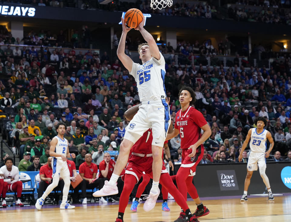 Creighton guard Baylor Scheierman (55) goes up for a basket as North Carolina State guards Jarkel Joiner (1) and Jack Clark (5) defend in the first half of a first-round college basketball game in the men's NCAA Tournament Friday, March 17, 2023, in Denver. (AP Photo/John Leyba)