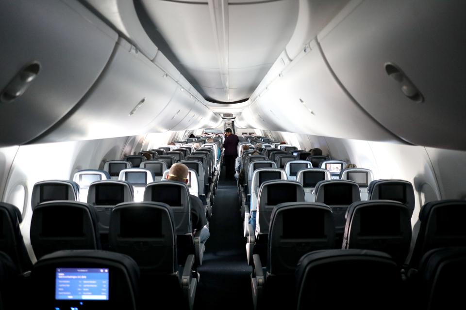 A flight attendant checks on passengers on a recent Delta flight from Atlanta.