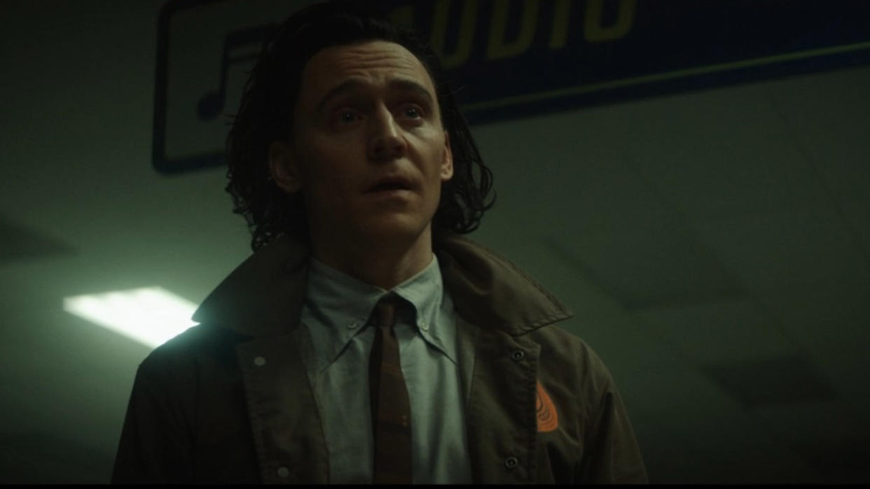  Tom Hiddleston' Loki stares at someone off camera in episode 2 of his self-titled TV show 