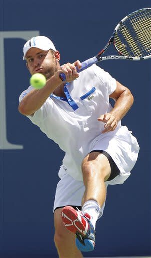 Andy Roddick returns a shot during the final match against Gilles Muller at the Atlanta Open tennis tournament on Sunday, July 22, 2012, in Atlanta. (AP Photo/John Bazemore)