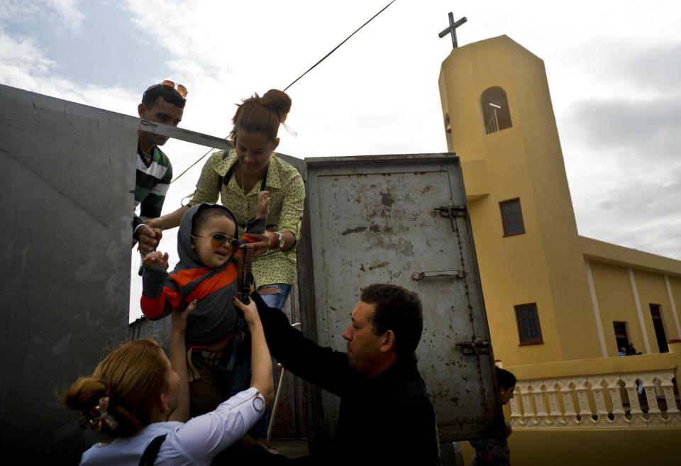 Faithful arrive for the consecration Mass of the Sagrado Corazon de Jesus Catholic church or Sacred Heart, in Sandino, Cuba, Saturday, Jan. 26, 2019. Of the three Catholic churches the Cuban government has authorized, it's the first one in 60 years to be completed. It was finished with the help of Tampa's St. Lawrence Catholic Church in Florida. (AP Photo/Ramon Espinosa)