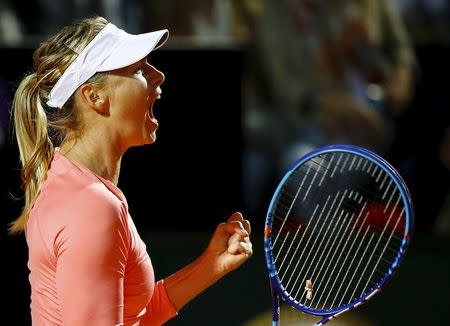 Maria Sharapova of Russia celebrates after winning her women's quarter-final match against Victoria Azarenka of Belarus at the Rome Open tennis tournament in Rome, Italy, May 15, 2015. REUTERS/Stefano Rellandini