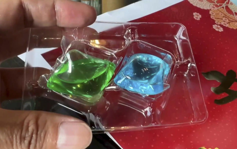 This image taken from video shows liquid laundry detergent balls inside a package given by Nationalist Party (KMT) as a gift for supporter in Chunghwa, Central Taiwan, Saturday Jan. 6, 2024. At least three people have been hospitalized after mistakenly eating colorful pods of liquid laundry detergent that were distributed as a campaign freebie in Taiwan’s presidential race. (TVBS via AP)