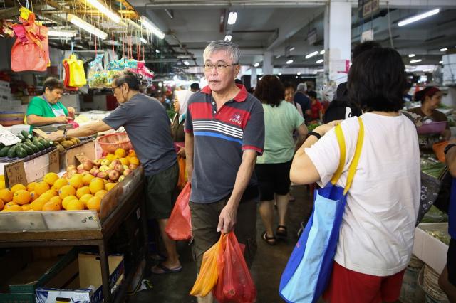 Malaysian Grocery Shoppers in a shopping frenzy at a Vegetable