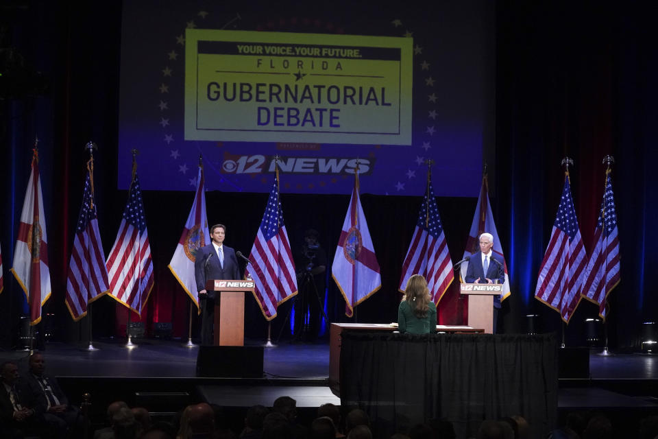 Republican Gov. Ron DeSantis, left, and former Gov. Charlie Crist, D-Fla., participate in a debate at the Sunrise Theatre, Monday, Oct. 24, 2022, in Fort Pierce, Fla. (Crystal Vander Weit/TCPalm.com via AP, Pool)