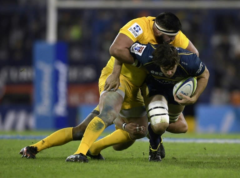 The ACT Brumbies' lock Sam Carter (R) is tackled by the Jaguares' Ramiro Herrera (C) and Lucas Noguera Paz during their Super Rugby match, at Jose Amalfitani stadium in Buenos Aires, on May 27, 2017