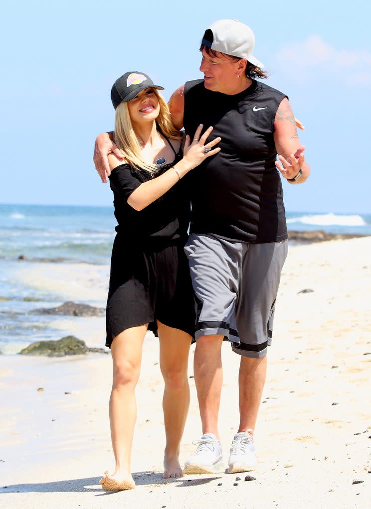 Richie Sambora and Orianthi Panagaris walk on the beach.