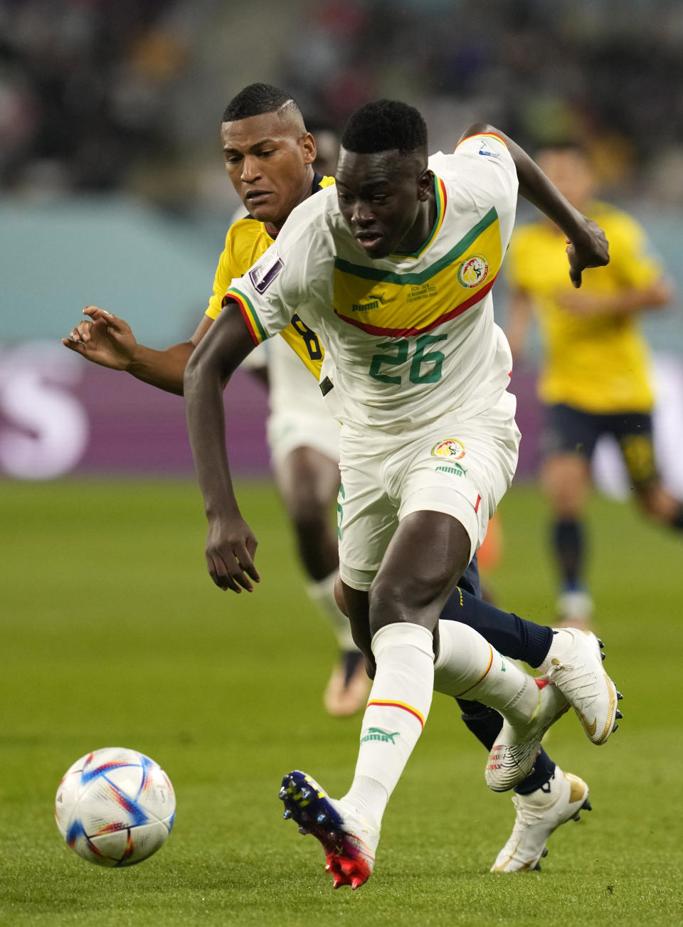 Senegal's Pape Gueye, right, controls the ball away from Ecuador's Carlos Gruezo during the World Cup group A soccer match between Ecuador and Senegal, at the Khalifa International Stadium in Doha, Qatar, Tuesday, Nov. 29, 2022. (AP Photo/Themba Hadebe)