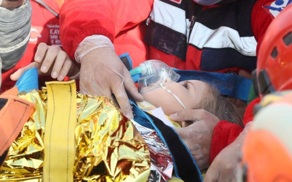 Rescue workers carry four-year-old Ayda Gezgin out from a collapsed building, four days after after an earthquake near the Turkish city of Izmir - AFAD
