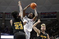 UConn guard Tristen Newton (2) is fouled by Arkansas-Pine Bluff forward Lonnell Martin Jr. (23) in the first half of an NCAA college basketball game, Saturday, Dec. 9, 2023, in Storrs, Conn. (AP Photo/Jessica Hill)