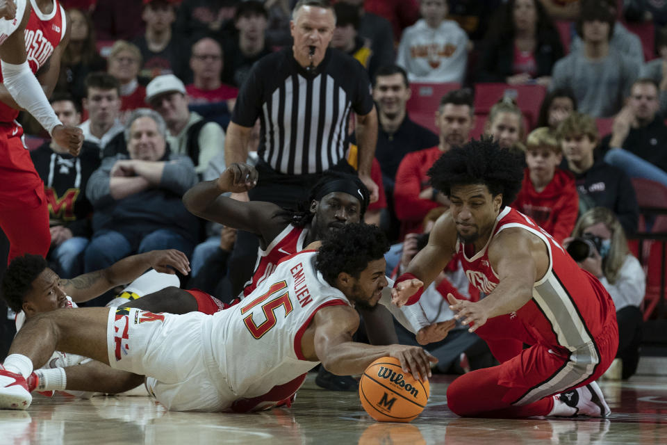 Maryland's Patrick Emilien (15) fights for the ball with Ohio State's Justice Sueing, right, during the first half of an NCAA college basketball game, Sunday, Jan. 8, 2023, in College Park, Md. (AP Photo/Jose Luis Magana)