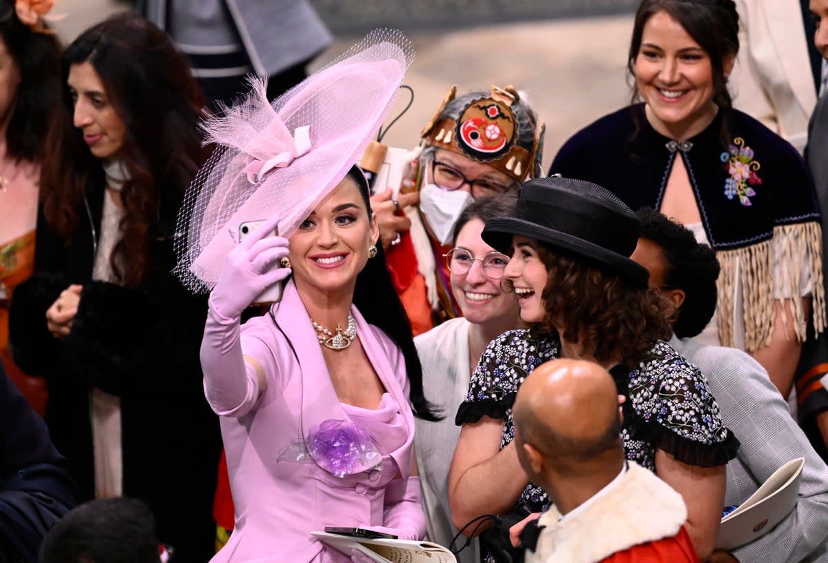 Katy Perry takes selfies with guests during the Coronation of King Charles III and Queen Camilla (Gareth Cattermole/Getty)