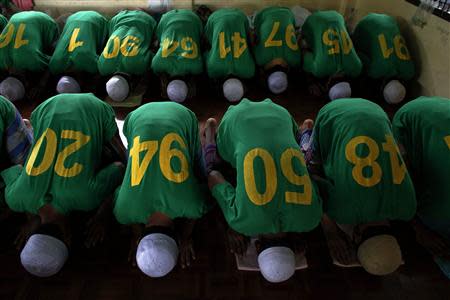 Rohingya Muslim illegal immigrants pray at the Immigration Detention Centre during the Muslim holy fasting month of Ramadan in Kanchanaburi province, in this file picture taken July 10, 2013. REUTERS/Athit Perawongmetha/Files