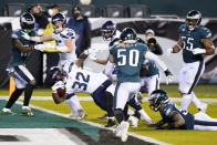 Seattle Seahawks' Chris Carson (32) scores a touchdown during the first half of an NFL football game against the Philadelphia Eagles, Monday, Nov. 30, 2020, in Philadelphia. (AP Photo/Chris Szagola)