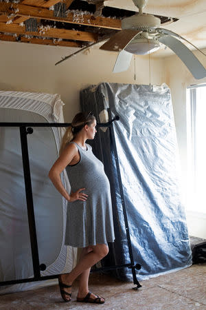 Jennifer Maher, pregnant in her third trimester, looks over the post-Hurricane Florence damage to her home at Marine Corps Base Camp Lejeune, North Carolina, U.S., September 27, 2018. REUTERS/Andrea Januta