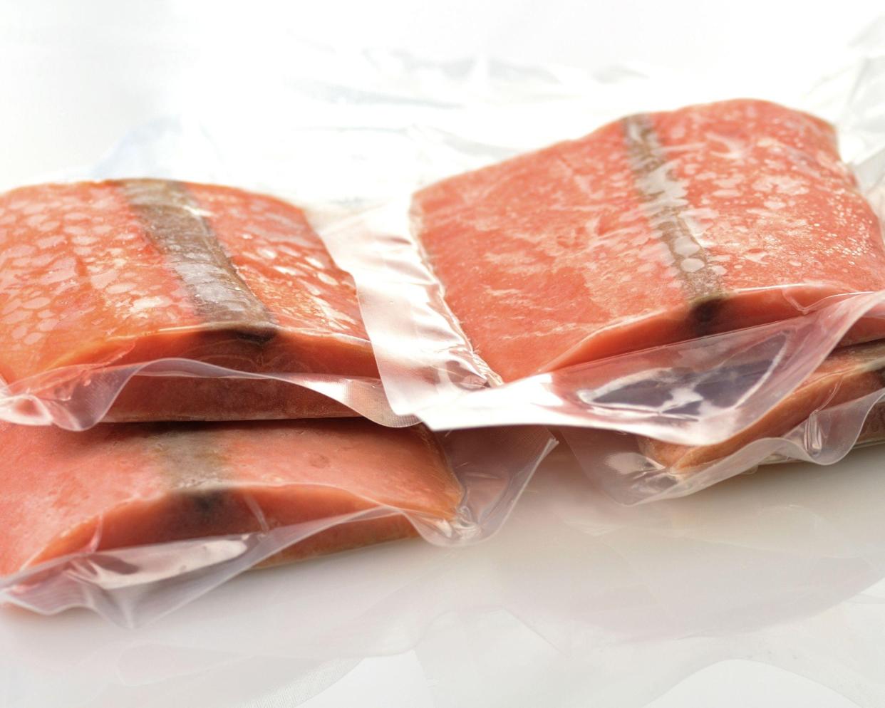 Vacuum packed frozen salmon fillets