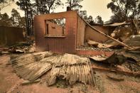 The remains of a house destroyed by a bushfire is seen just outside Batemans Bay in New South Wales on Jan. 2, 2020. Australia authorized the forced evacuation of residents amid a mass exodus of tourists from fire-ravaged coastal communities, as the country braces for a weekend heatwave expected to fan deadly bushfires. (Photo by PETER PARKS/AFP via Getty Images)