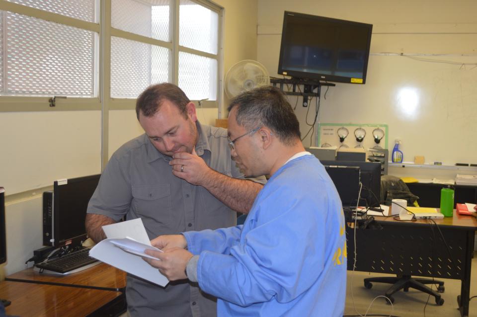 Professor Peter Fulks of Cerro Coso Community College goes over an assignment with one of his students during his Concepts of Criminal Law class at Tehachapi prison.