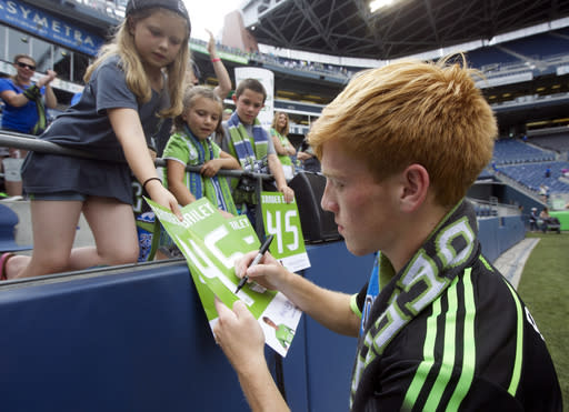 Seattle Sounders&#39; Xander Bailey signs autographs for fans following a friendly soccer match against Tottenham Hotspur in Seattle, Saturday, July 19, 2014. The matched ended in a 3-3 draw. Bailey was signed to the Sounders for the match as part of the Make-A-Wish program. (AP Photo/Stephen Brashear)