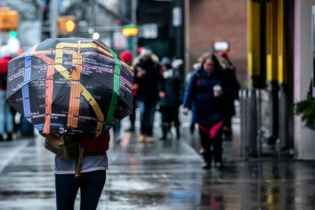 A pedestrians walks in the rainy day near Time Square in the Manhattan borough of New York City, New York, U.S., January 20, 2019.REUTERS/Jeenah Moon