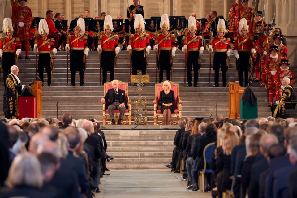 King Charles III, left, and Camilla, the Queen Consort sit inside Westminster Hall, where both Houses of Parliament met on Monday to express their condolences following the death of Queen Elizabeth II (AP)