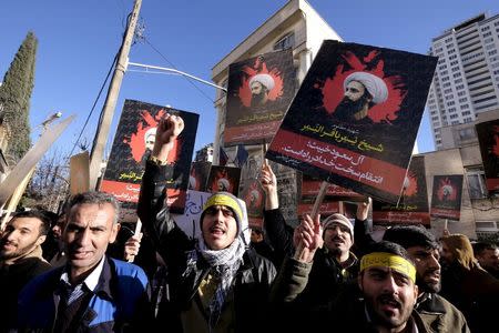 Iranian protesters chant slogans as they hold pictures of Shi'ite cleric Sheikh Nimr al-Nimr during a demonstration against the execution of Nimr in Saudi Arabia, outside the Saudi Arabian Embassy in Tehran January, 3, 2016. REUTERS/Raheb Homavandi/TIMA