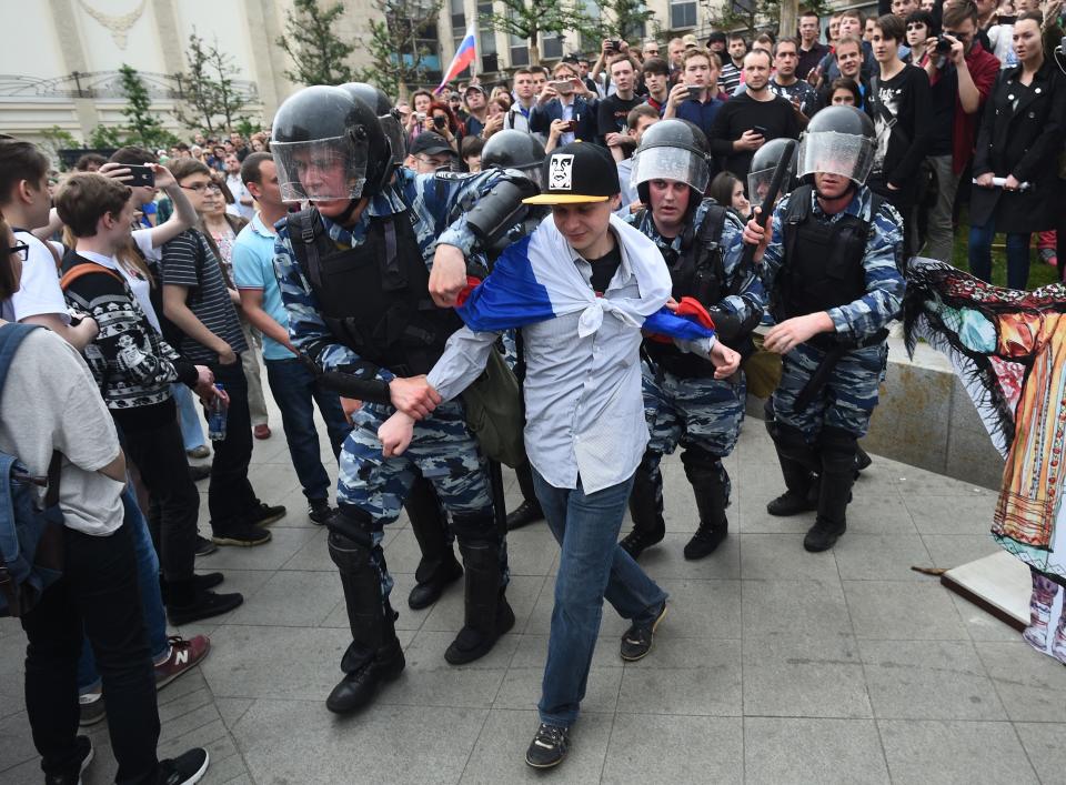 Russian police officers detain a participant.&nbsp;