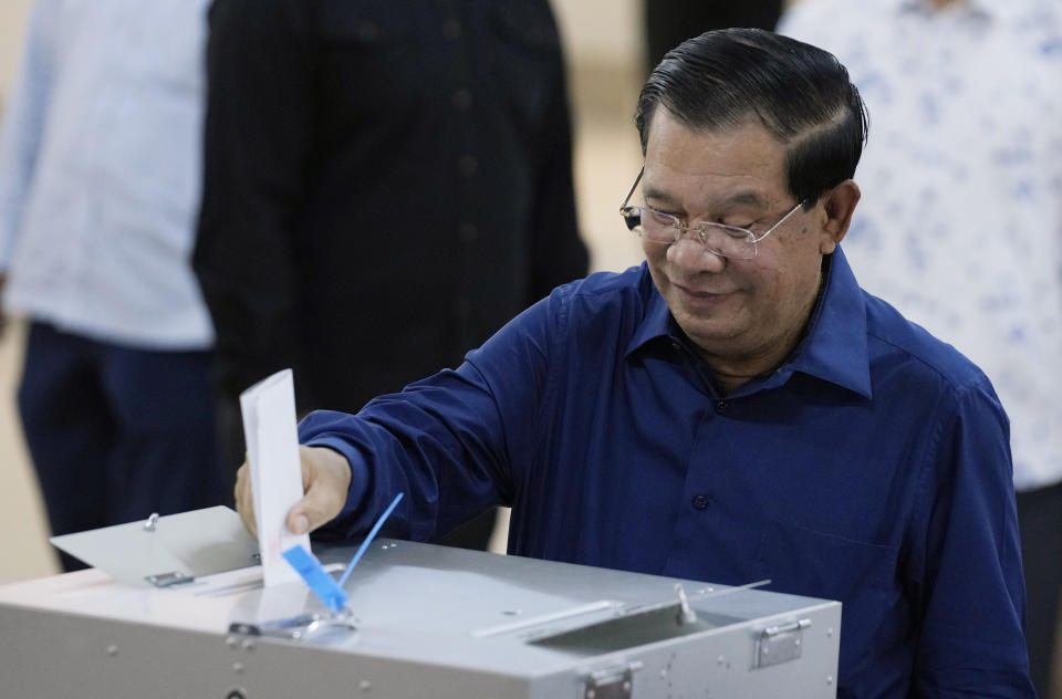 Cambodian Prime Minister Hun Sen of the Cambodian People's Party (CPP) drops a ballot into a box for voting at a polling station at Takhmua in Kandal province, southeast Phnom Penh, Cambodia, Sunday, July 23, 2023. Cambodians go to the polls Sunday with incumbent Prime Minister Hun Sen and his party all but assured a landslide victory thanks to the effective suppression and intimidation of any real opposition that critics say has made a farce of democracy in the Southeast Asian nation. (AP Photo/Heng Sinith)