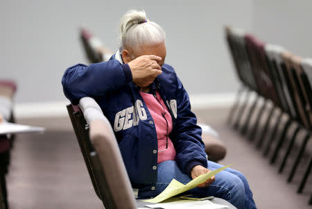 A Stacey Abrams supporter looks over a sample ballot at Kingdom Builders Covenant Church in Conyers, Georgia, U.S.,October 26, 2018. REUTERS/Lawrence Bryant