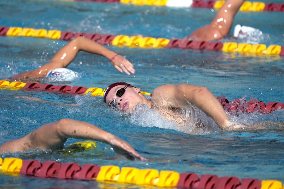 French Olympic swimmer Leon Marchand trains with his Arizona State University teammates, Tuesday, Feb. 13, 2024, in Tempe, Ariz. With family and friends — an entire nation — watching, the individual medley specialist is poised to be one of the premier faces of these Olympics. (AP Photo/Ross D. Franklin)