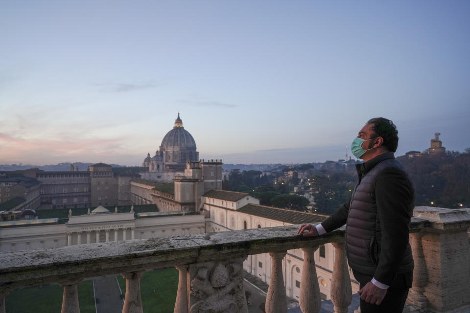 Gianni Crea, the Vatican Museums chief "Clavigero" key-keeper, poses for a photo on the "Nicchione" terrace on his way to open the museum's rooms and sections, the Vatican, Monday, Feb. 1, 2021. Crea is the “clavigero” of the Vatican Museums, the chief key-keeper whose job begins each morning at 5 a.m., opening the doors and turning on the lights through 7 kilometers of one of the world's greatest collections of art and antiquities. The Associated Press followed Crea on his rounds the first day the museum reopened to the public, joining him in the underground “bunker” where the 2,797 keys to the Vatican treasures are kept in wall safes overnight. (AP Photo/Andrew Medichini)