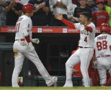 Los Angeles Angels' Shohei Ohtani is congratulated by Josd Iglesias after hitting a three-run home run during the fourth inning of a baseball game against the Colorado Rockies on Wednesday, July 28, 2021, in Anaheim, Calif. (AP Photo/John McCoy)