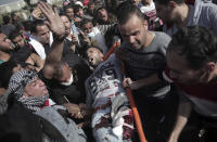 <p>Palestinian protesters carry a wounded man from during a protest at the Gaza Strip’s border with Israel, Friday, April 6, 2018. (Photo: Khalil Hamra/AP) </p>