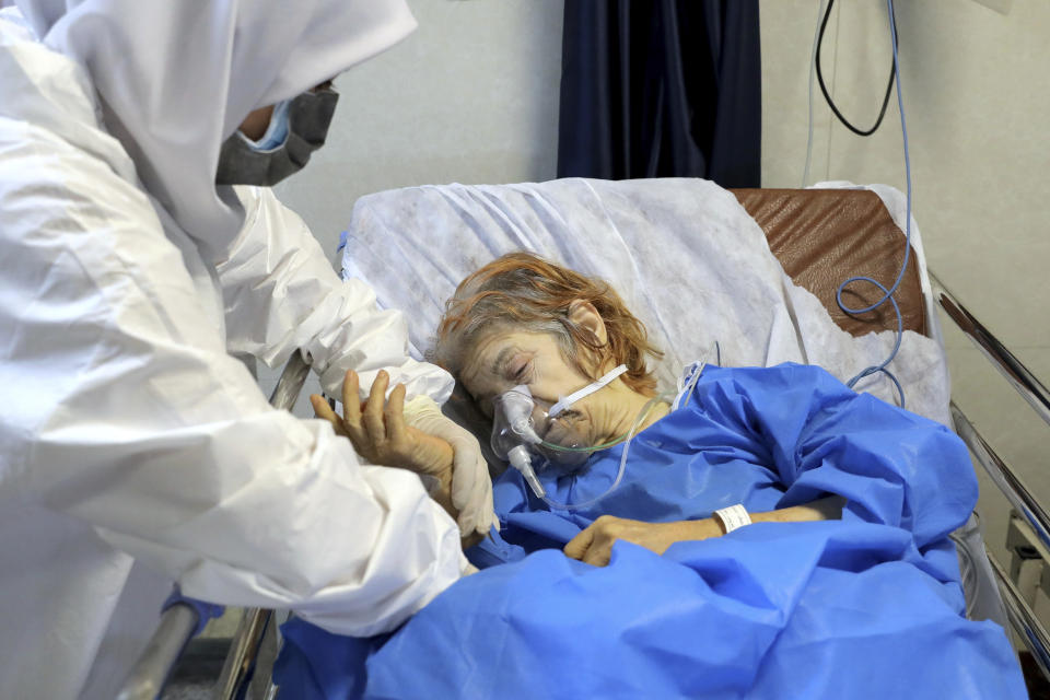 A nurse tends to a patient affected by the COVID-19 virus at the Shohadaye Tajrish Hospital in Tehran, Iran, Saturday, April 17, 2021. After facing criticism for downplaying the virus last year, Iranian authorities have put partial lockdowns and other measures in place to try and slow the coronavirus’ spread. (AP Photo/Ebrahim Noroozi)