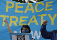 A protester wearing a face mask shouts slogan during a rally to demand the peace on the Korean peninsula and to stop sanctions against North Korea in front of Foreign Ministry before U.S. Deputy Secretary of State Stephen Biegun's arrival to meet with South Korean officials in Seoul, South Korea, Wednesday, July 8, 2020. Biegun arrived on Tuesday in the country on the first leg of his two-stop Asia trip and will meet officials in South Korea and Japan. The letters read "Lift sanctions on North Korea."(AP Photo/Lee Jin-man)