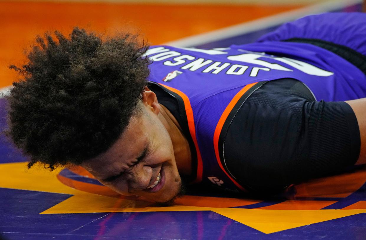 October 28, 2022; Phoenix, Ariz; USA; Suns Cam Johnson (23) lays on the ground after falling against the Pelicans during a game at the Footprint Center. Mandatory Credit: Patrick Breen-Arizona Republic