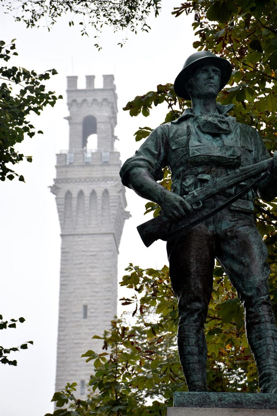 The Pilgrim Monument, 252 feet high, towers above a World War I statue in Provincetown, Massachusetts. The monument was dedicated in 1910 to recognize the 1620 landing of the Pilgrims nearby.
