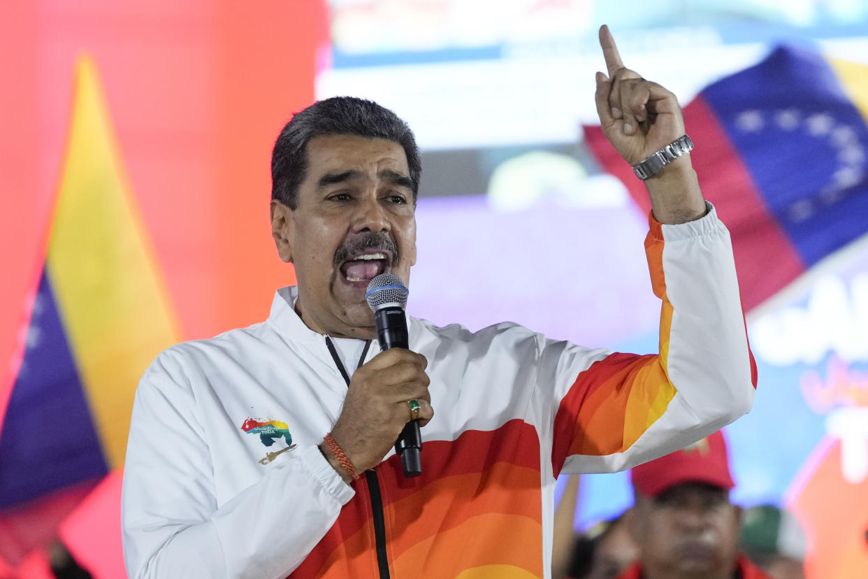 President Nicolas Maduro speaks to pro-government supporters after a referendum regarding Venezuela's claim to the Essequibo, a region administered and controlled by Guyana, in Caracas, Venezuela, Sunday, Dec. 3, 2023. Voters answered five questions about the future of the disputed land, including whether they support turning it into a Venezuelan state. (AP Photo/Matias Delacroix)