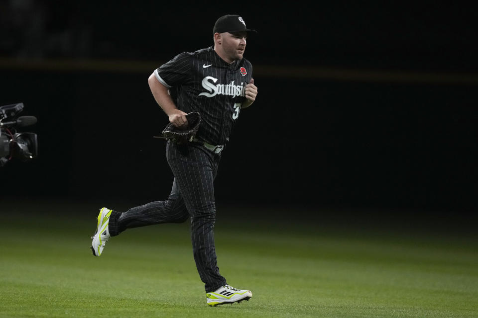 Chicago White Sox relief pitcher Liam Hendriks enters a baseball game during a flickering of the stadium lights to start the eighth inning against the Los Angeles Angels Monday, May 29, 2023, in Chicago. (AP Photo/Charles Rex Arbogast)