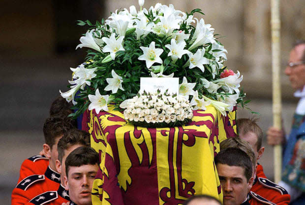 <p>Adorned with white lilies, Diana's coffin leaves Westminster Abbey.</p>