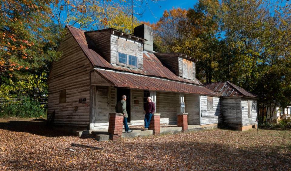 Myrick Howard, right, talks with Richard Hunter outside the Thomas Reynolds house in Warrenton, N.C. on Monday, Nov. 13, 2023. The home, which dates to the early 19th century, is also known as Reynolds Tavern and is being offered for sale by Preservation North Carolina.