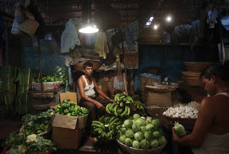 A vendor waits for customers at his stall at a wholesale food market in Mumbai October 14, 2013. REUTERS/Danish Siddiqui