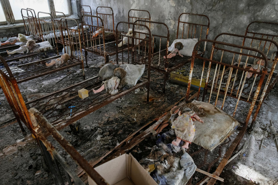 Vintage dolls, which were placed by a visitor, are seen on beds at a kindergarten near the Chernobyl nuclear power plant in the abandoned city of Pripyat, Ukraine April 5, 2017. Picture taken April 5, 2017. REUTERS/Gleb Garanich