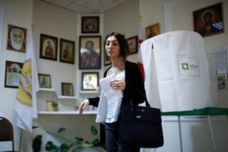 A woman leaves a voting booth during the parliamentary election in Tbilisi, Georgia, October 8, 2016. REUTERS/David Mdzinarishvili