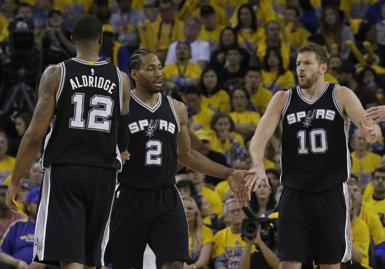 Kawhi Leonard (center) left Game 1 of the West finals after re-injuring his left ankle. (AP)