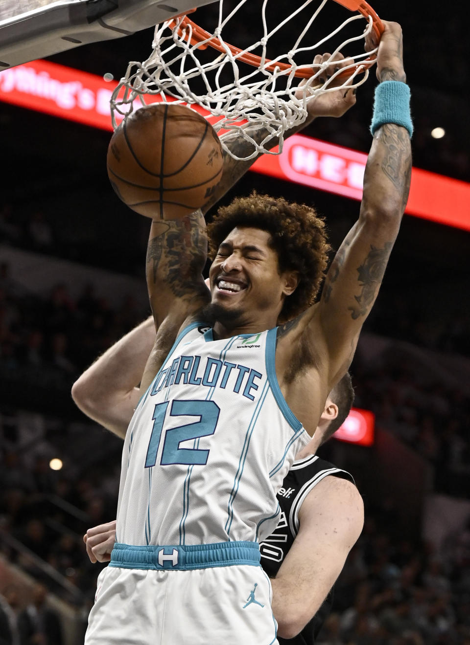 Charlotte Hornets' Kelly Oubre Jr. dunks during the first half of an NBA basketball game against the San Antonio Spurs, Wednesday, Oct. 19, 2022, in San Antonio. (AP Photo/Darren Abate)