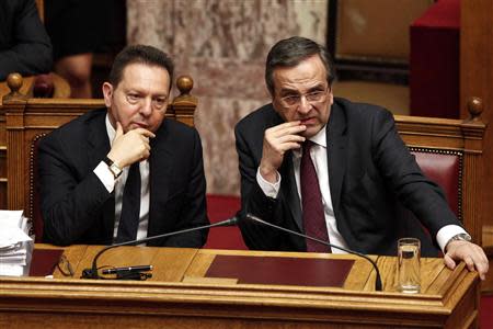 Greece's Prime Minister Antonis Samaras (R) and Finance Minister Yannis Stournaras (L) attend a parliament session before a vote for an omnibus reforms bill in Athens March 30, 2014. REUTERS/Alkis Konstantinidis